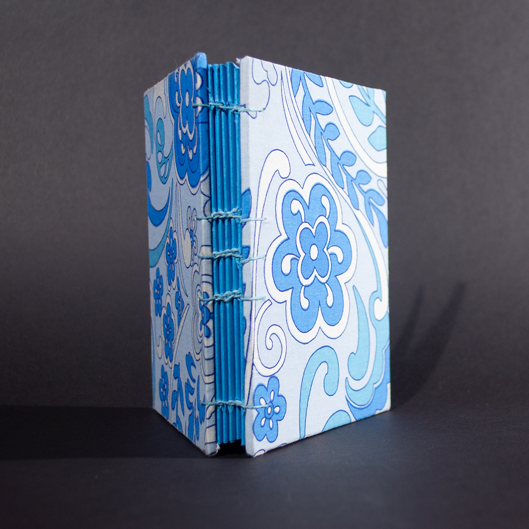 The spine of blue floral octavo Coptic bound journal