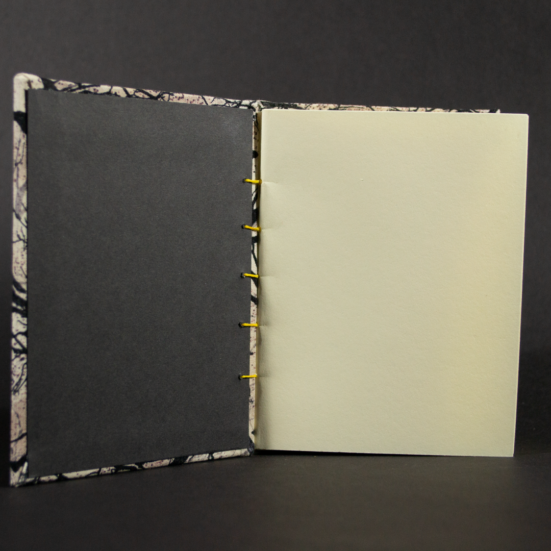 Insides of bat and raven octavo Coptic book with black end pages and ivory cotten pages