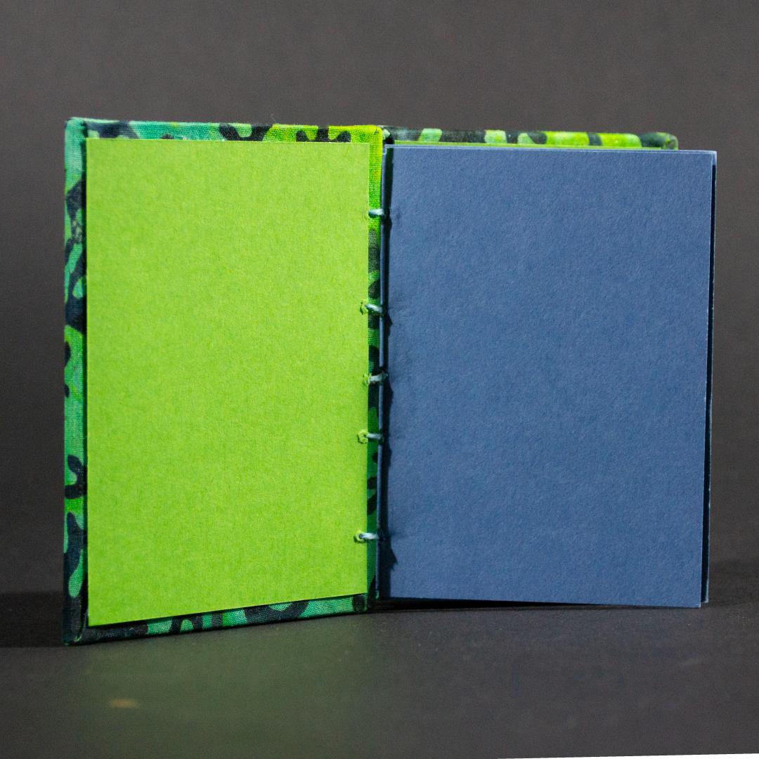 Insides of blue coral batik mini Coptic book showing the blue cardstock pages and green end pages.
