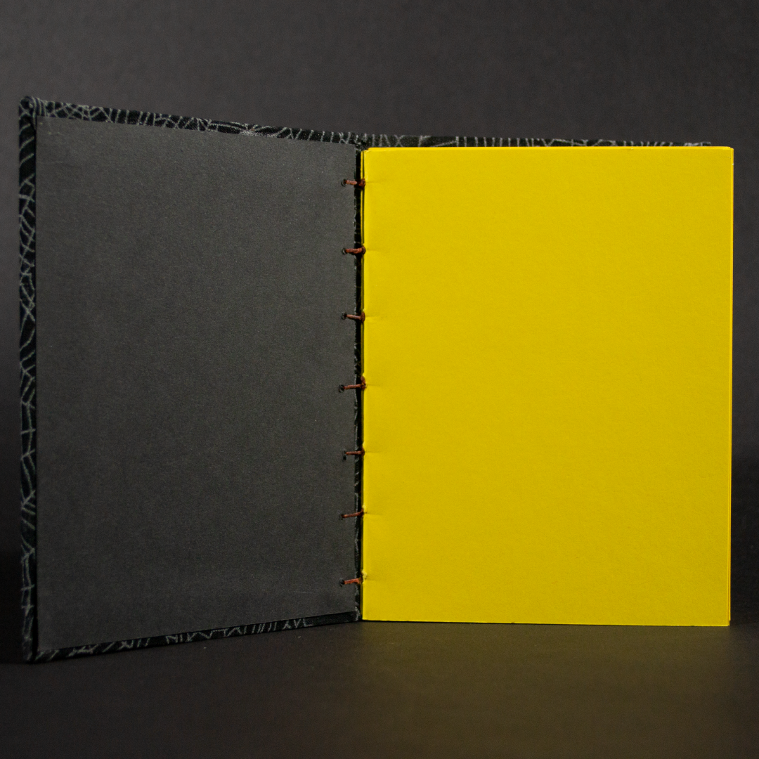 Insides of cobwebs octavo Coptic book with yellow cardstock pages and black end pages