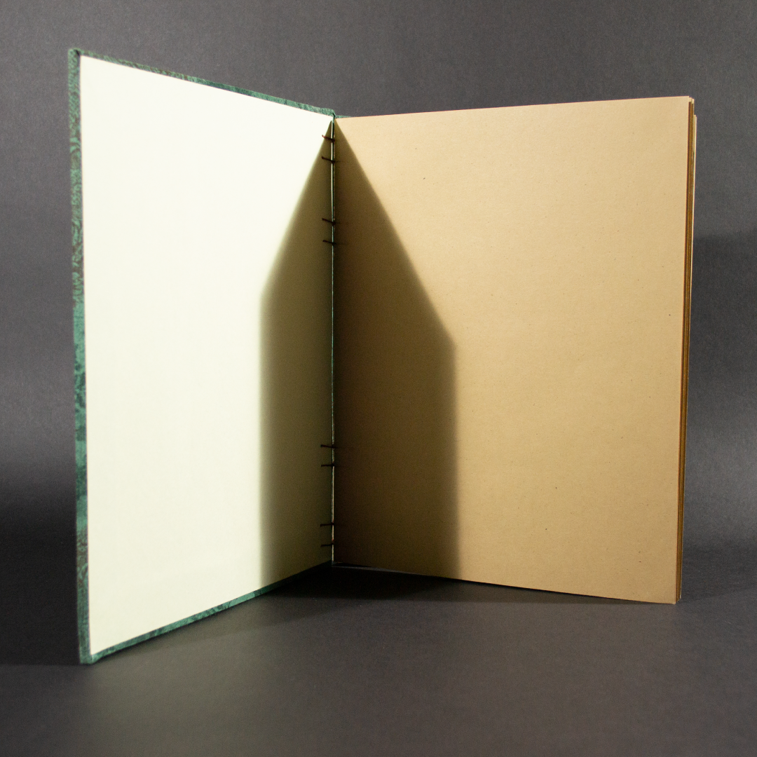 Insides of vintage lace folio coptic journal showing the recycled paper and ivory end pages.