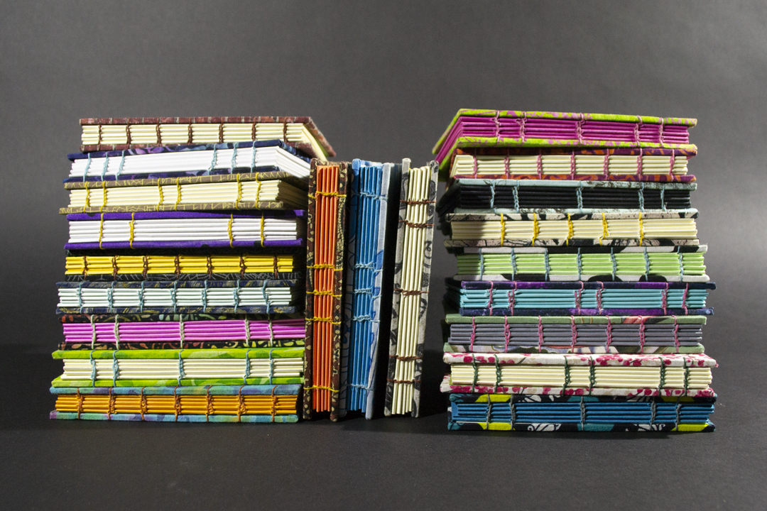 A stack of Coptic bound blank notebooks.