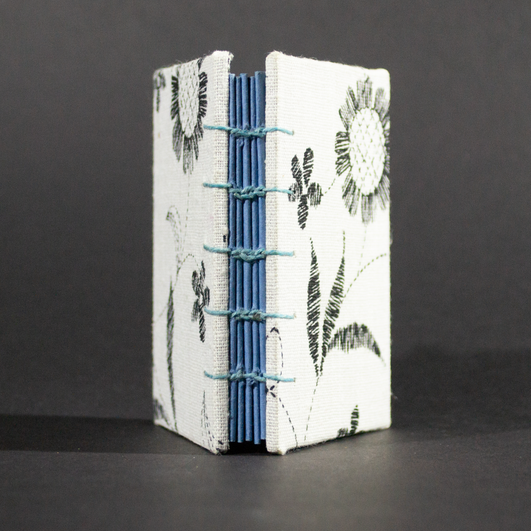 Spine view of black and white floral mini Coptic book