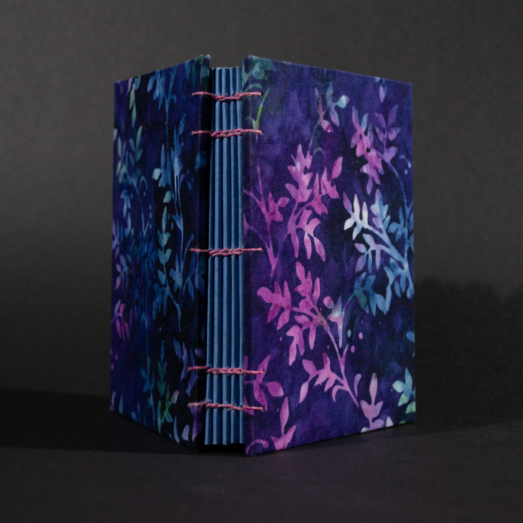Spine view of purple vines batik octavo Coptic book