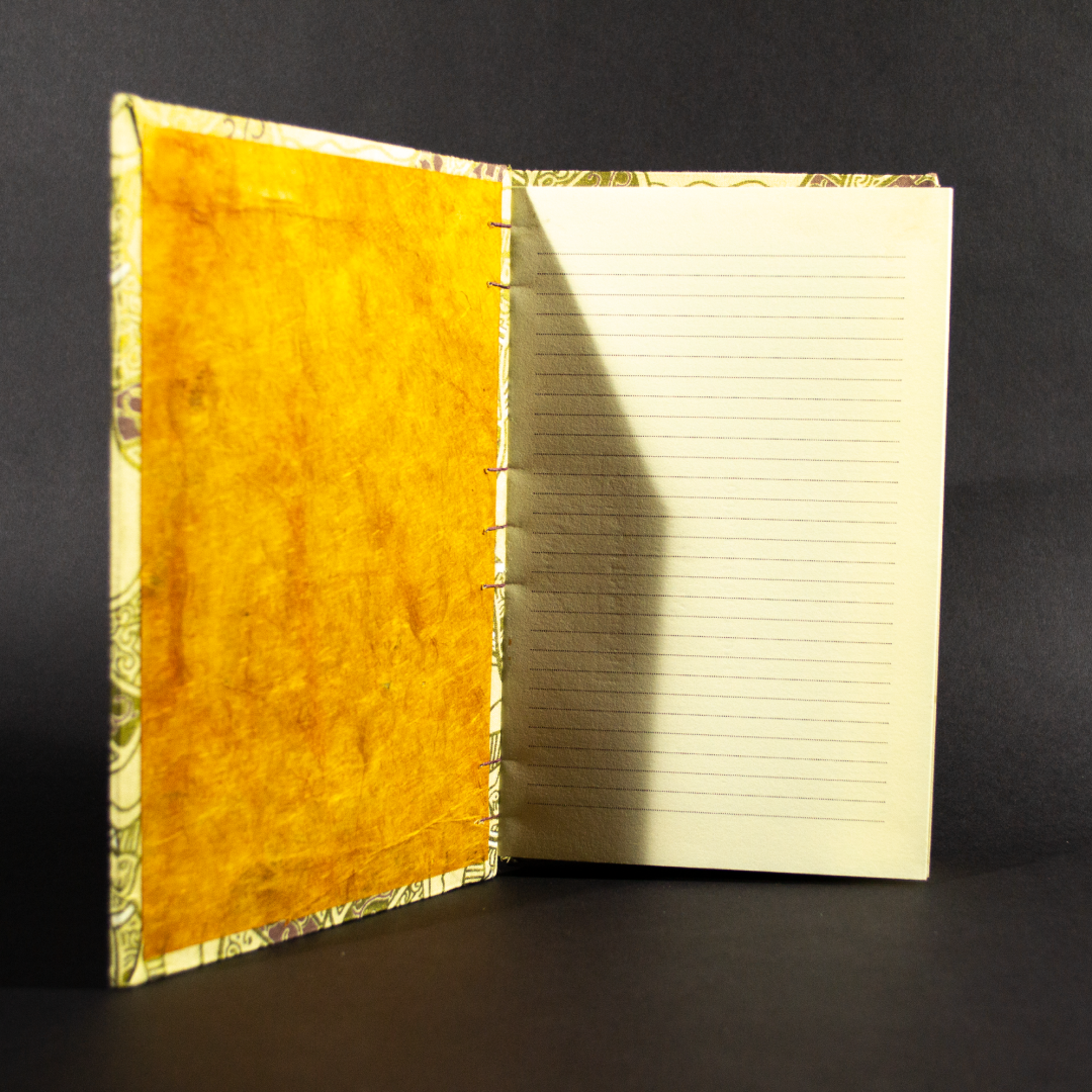 Inside of four jugs lined quarto Coptic bound journal showing orange end pages and lined ivory text pages