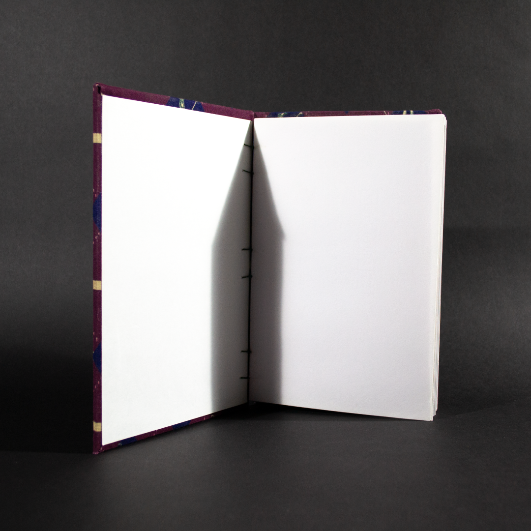 Inside of retro golfers quarto Coptic bound journal with matching white end and text pages.