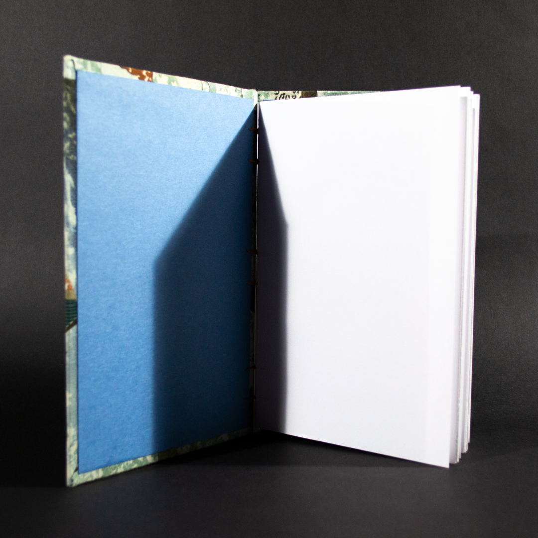Insides of Egyptian pharaoh themed quarto Coptic bound journal showing the blue end pages and white cotton text pages